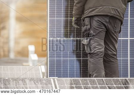 The Process Of Installing Solar Panels. Solar Panel Installers Work On The Roof. Installers Carry So