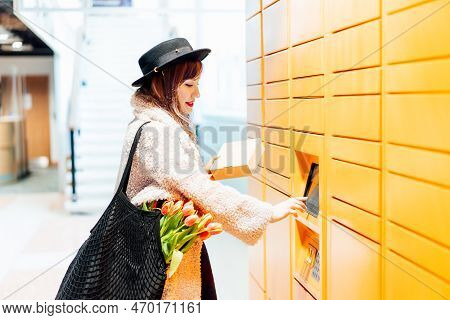 Fashion Woman With Box Using Modern Postal Automatic Mail Terminal With Self Service Device For Pick