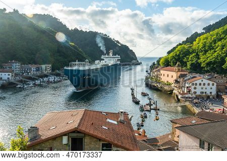 Entrance Of A Giant Merchandise Ship In The Bay Of Pasaia To The Open Sea Pasajes, Gipuzkoa, Spain