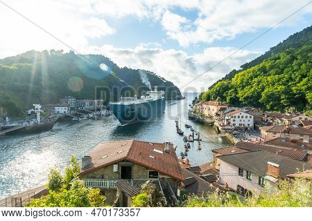 Entrance Of A Giant Merchandise Ship In The Bay Of Pasaia To The Open Sea Pasajes, Gipuzkoa, Spain