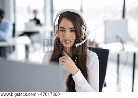 Portrait Of Dedicated Female Operator Agent Working At It Support Sector