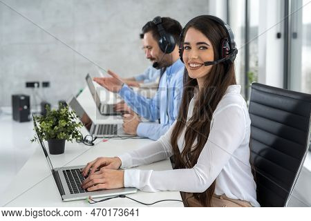 Portrait Of Dedicated Female Operator Agent Working At It Support Sector