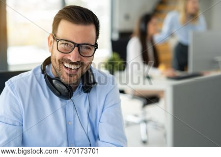 Portrait Of Dedicated Female Operator Agent Working At It Support Sector