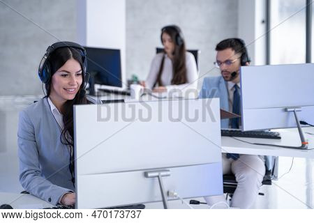 Portrait Of Dedicated Female Operator Agent Working At It Support Sector