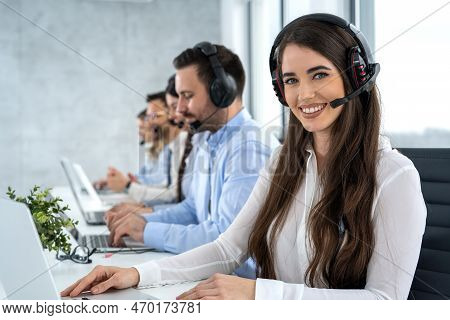 Portrait Of Dedicated Female Operator Agent Working At It Support Sector