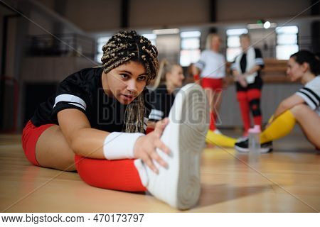 Group Of Multiaged Women, Sports Team Players. In Gym Stretching, Warming Up Before Match.