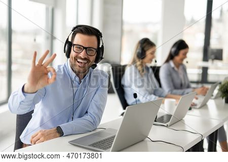 Portrait Of Dedicated Female Operator Agent Working At It Support Sector