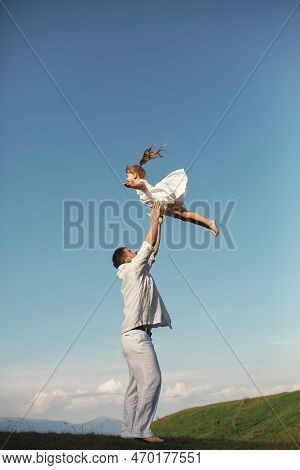 Father Playing With Ittle Daughter In A Mountains