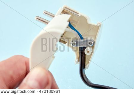 Disassembled European Standard Electric Plug And An Electrical Cord Connected To It.