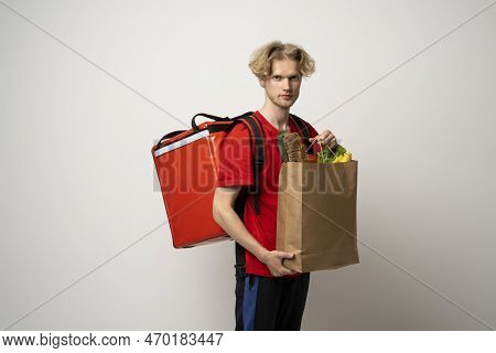 Sive View Handsome Delivery Man, Courier Carrying Package Bag Of Grocery Food And Drinks From Store,