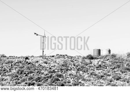 A Landscape, With A Wind Generator And Two Water Tanks On A Hill On The Road Between Loxton And Fras