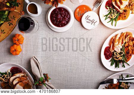 Festive Thankgiving Dinner Table With Plates Of Food, Turkey And All The Sides With Copy Space