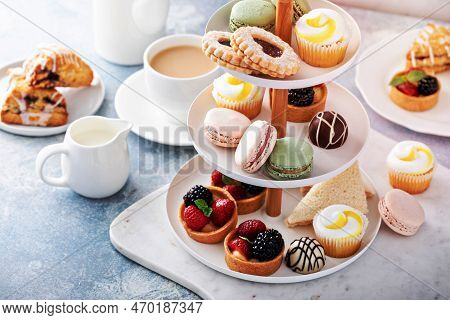 Spring Or Summer Dessert Table, Three Tiered Tray With Variety Of Desserts And Sandwiches For Tea