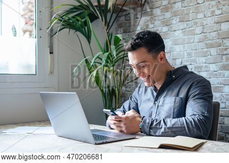 Confident Man Sitting At Desk Taking Break In Work With Electronic Documents On Laptop To Make Answe