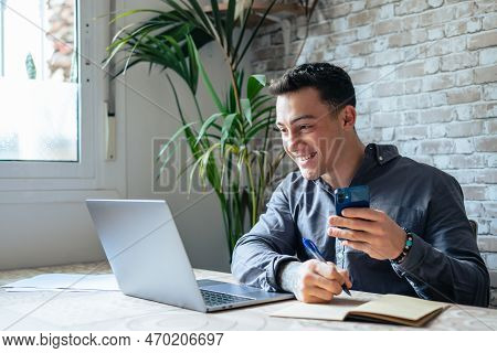 Confident Man Sitting At Desk Taking Break In Work With Electronic Documents On Laptop To Make Answe
