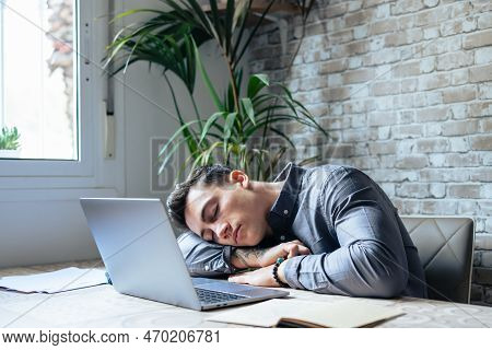 Exhausted Young Caucasian Male Employee Sleep Desk At Office Overwork Preparing Report. Tired Male F