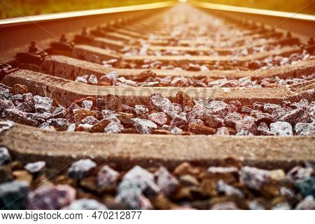 Railway Track Line In Sunlight, Beautiful Train Track Landscape. Railroad With Ballast Gravel, Rails