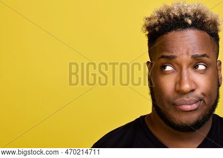 Ddoubting Guy Looks Away With A Smirk. A Dark-skinned Man With A Beard With A Smirk On His Face Look