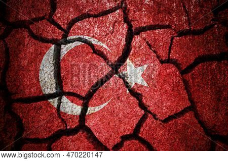Earthquake In Turkey. Turkey Flag On The Cracked Earth. Cracked Turkey Flag.