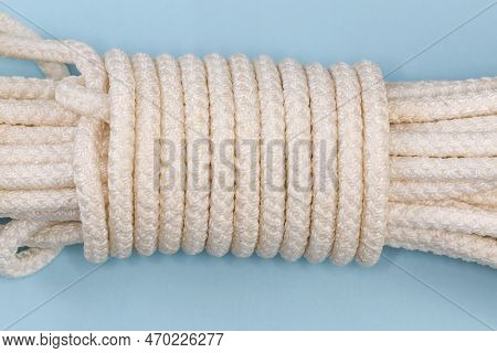 Bight Of The Accessory Cord Tied With Alpine Coil Knot, Fragment Of The Bight Close-up On A Blue Bac