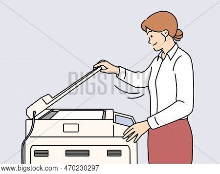 Young Businesswoman Making Document Copy On Machine In Office. Smiling Female Employee Working On Pr