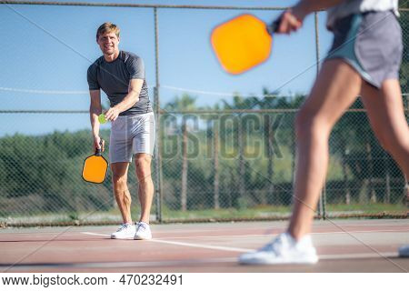 Couple Playing Pickleball Game, Hitting Pickleball Yellow Ball With Paddle, Outdoor Sport Leisure Ac