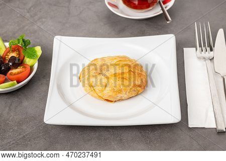 Izmir Boyoz On A White Porcelain Plate On A Stone Table
