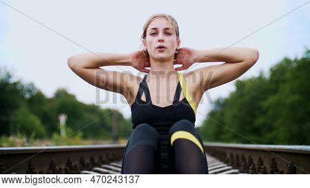 Beautiful Sexy Athletic Young Blond Woman In Black Leggings Performing Exercises To Make Strong Pres