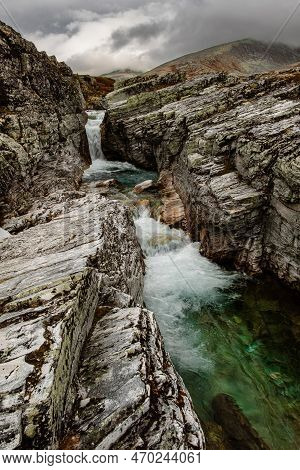 Autumn Mountain Landscape Of Rondane National Park In Norway, Waterfall And Near Peer Gynt Hytta
