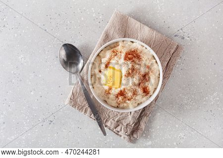 Rice Pudding With Butter Cinnamon. French Riz Au Lait, Norwegian Risgrot, Traditional Breakfast Dess