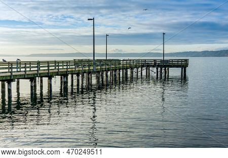 Overcast Clouds Hang Above A Pier In Redondo Brach, Wshington.