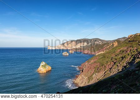 Rocky Cliffs On The Sea Coast. Sardinia, Italy. Nature Background