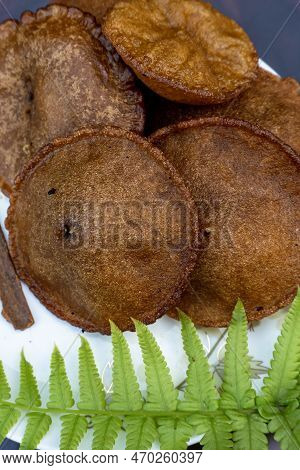 Oil Cake With Green Leaves, Which Is Called Tele Pitha In Bangladesh. Traditional Oil Cake.