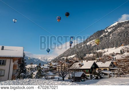 Chateau D\'oex, Switzerland - January 29. 2023: Hot Air Balloons Flying. International Hot Air Ballo