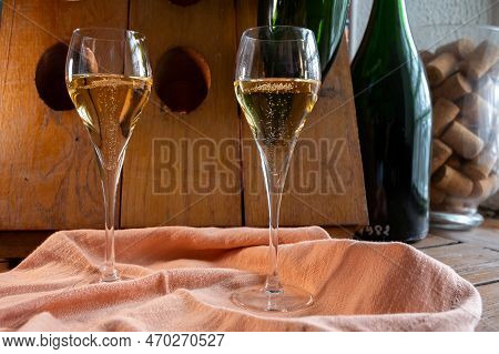 Glasses Of Sparkling White Wine Champagne Or Cava With Bubbles And Classic Wooden Champagne Pupitre