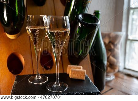 Glasses Of Sparkling White Wine Champagne Or Cava With Bubbles And Classic Wooden Champagne Pupitre