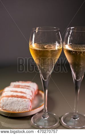 Glasses Of Sparkling White Wine Champagne Or Cava With Bubbles And Sweet Dessert Reims Rose Biscuits