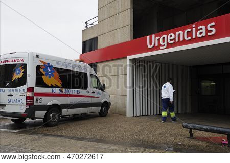 Valencia, Spain - December 08, 2022: Ambulance At The Entrance To The Hospital, The Nurse Goes Insid
