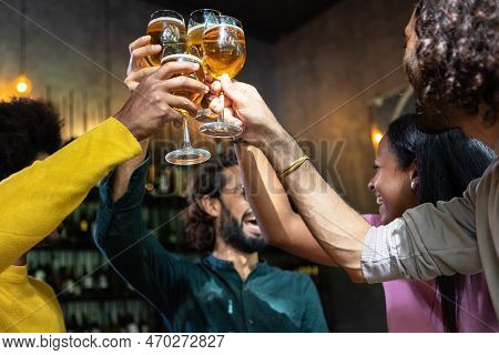Young Group Of Multiracial People Toasting Cold Beer At Happy Hours Brewery Bar. After Work Concept
