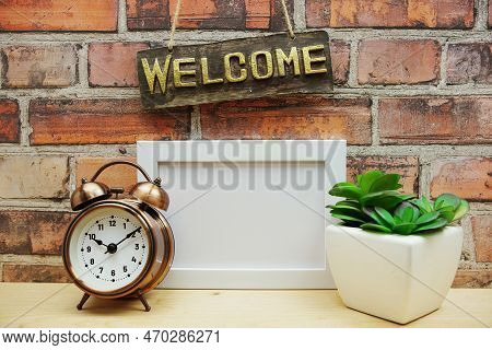 Empty Photo Frame Mock Up With Welcome Sign And Artficial Plant Home Decoration