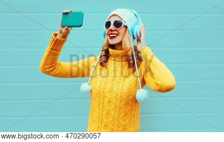 Winter Portrait Smiling Woman Taking Selfie Picture By Phone While Listening To Music In Wireless He