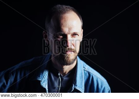 Concentraited Middle Age Man In Denim Shirt Looking Squinting To The Side