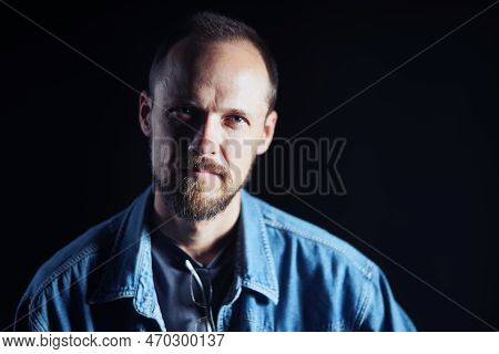 Concentraited Middle Age Man In Denim Shirt Looking Squinting At Camera