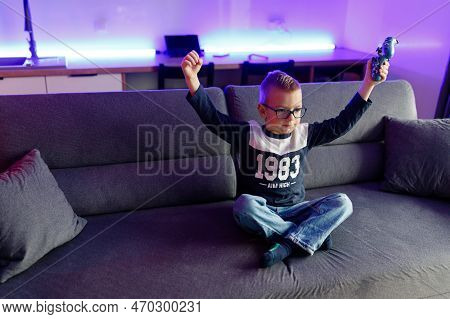 Boy Danya In Glasses Plays On A Game Console.
