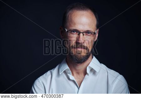 Concentraited Middle Age Man In White Shirt And Eyeglasses Looking Squinting At Camera