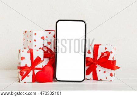 Mobile Phone With Blank Screen On Colored Background With Hearts, Calendar And Gift Box, Valentine D