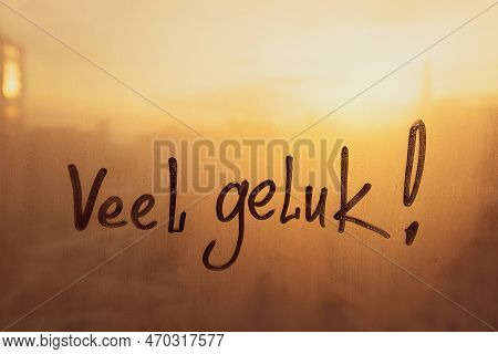 Handwritten Netherlandish Dutch Language Message Veel Geluk Is Luck On Misted Glass On Sunset Window