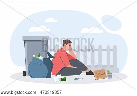 Poor Man Concept. Young Guy Sitting On Street Near Dumpster And Trashcan. Bankruptcy And Economic Cr