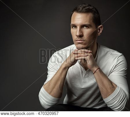 Handsome Young Man. Elegant Fashion Men Face Portrait Looking At Camera In White Shirt Over Dark Gra
