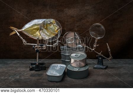Still Life With Moonfish, Canned Food And A Magnifying Glass.